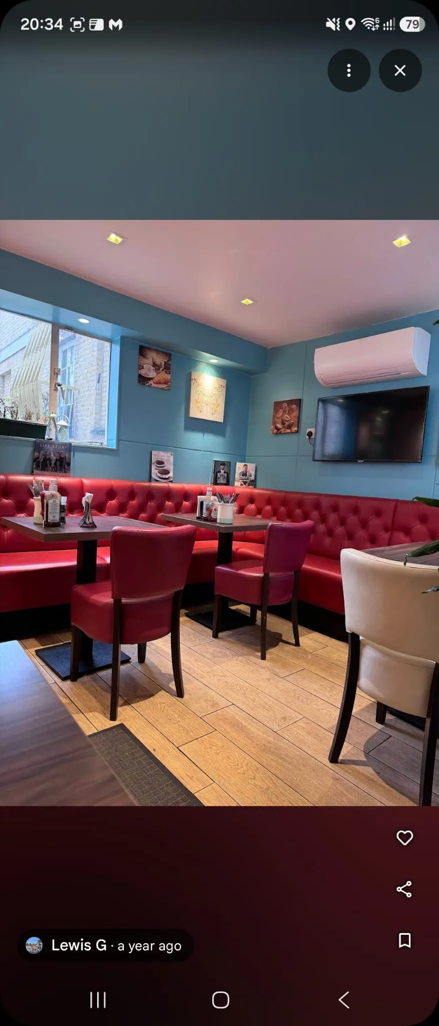 Eddie's Food Bistro interior with red banquette seating and sky-blue walls